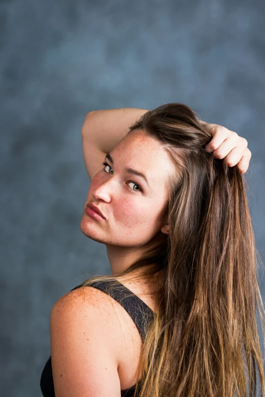 an image of a beautiful young woman with her hair blowing in the wind