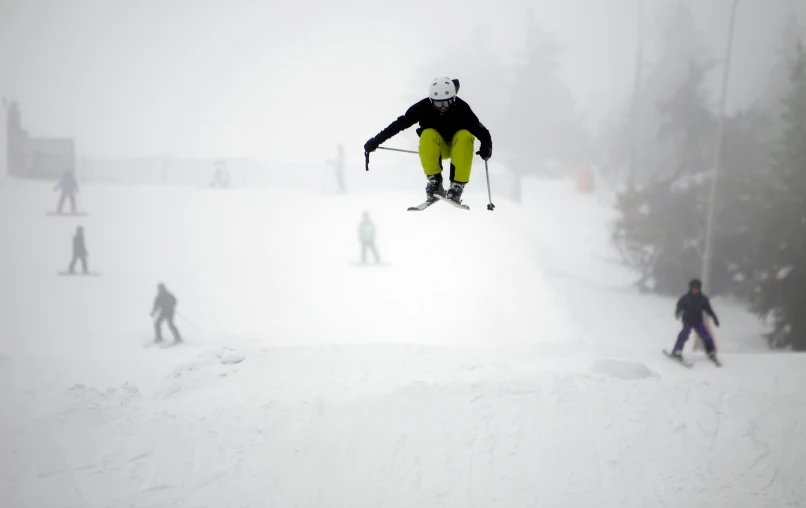 the skier jumps up into the air in the snow