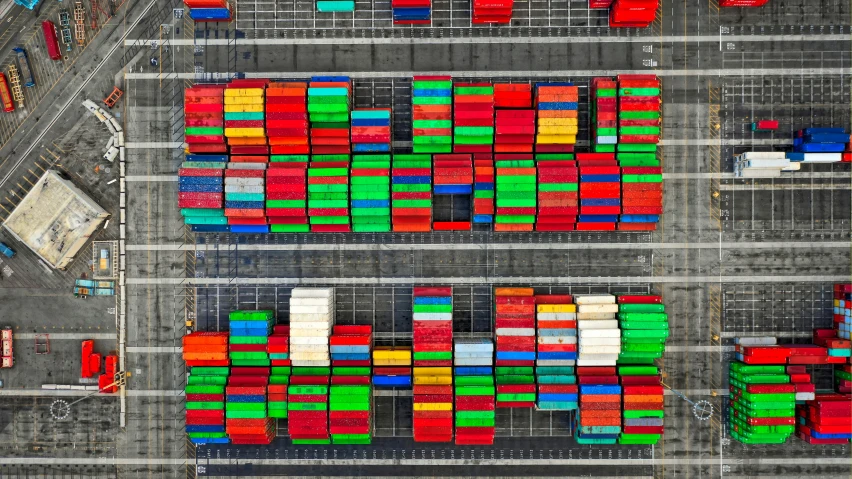 an aerial view of many cargo containers stacked on top of one another