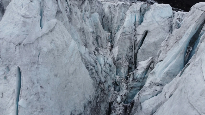 an ice climber is descending a steep mountain