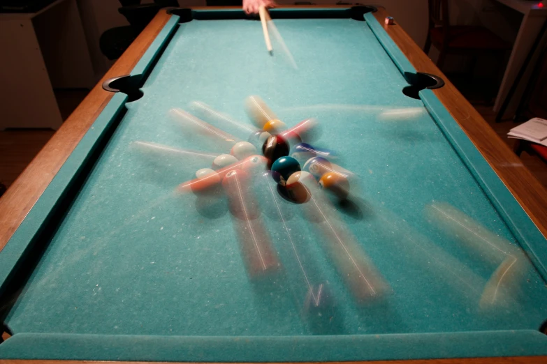 a pool table with pool cues and a cue