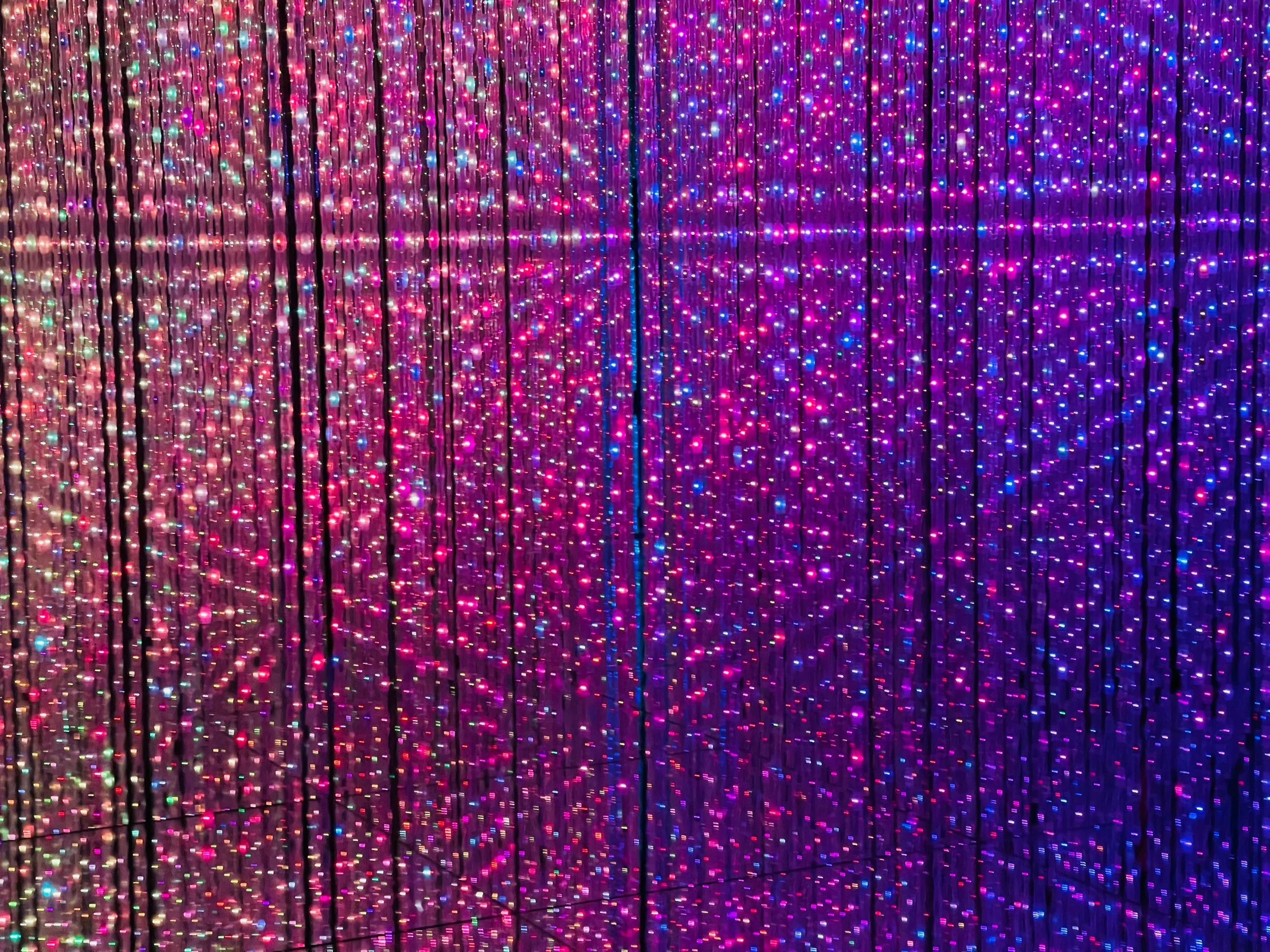 a colorful wall with various strands hanging off the side