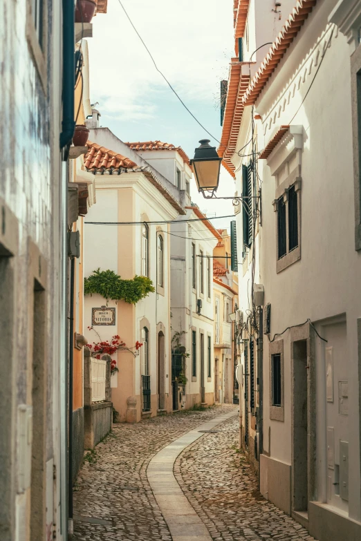 a cobblestone street with buildings on both sides