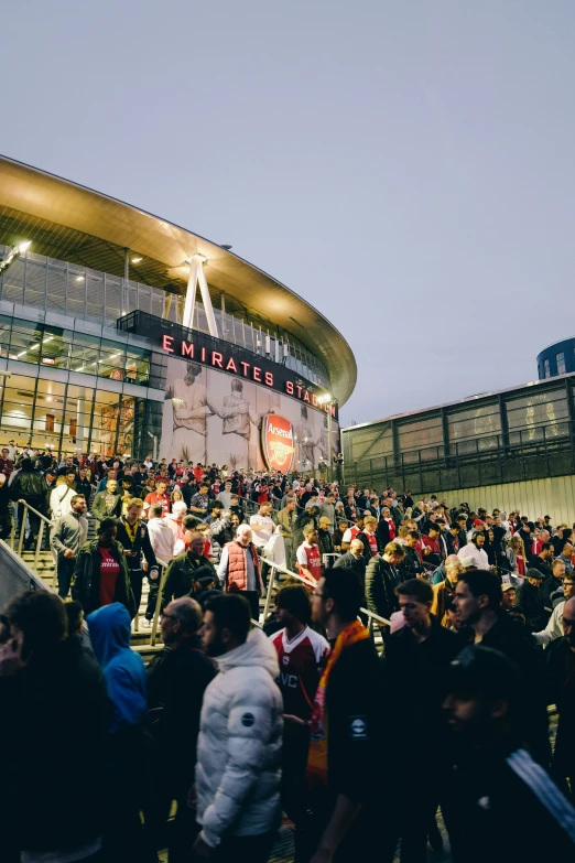 a large group of people standing in front of a building