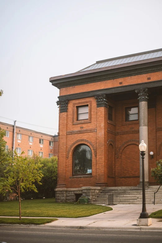 an old red brick building with a white clock tower