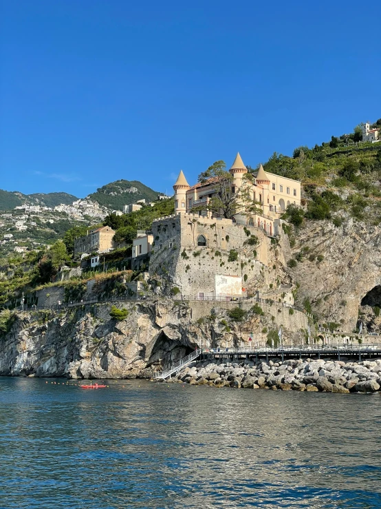 a castle on the top of a hill on the shore