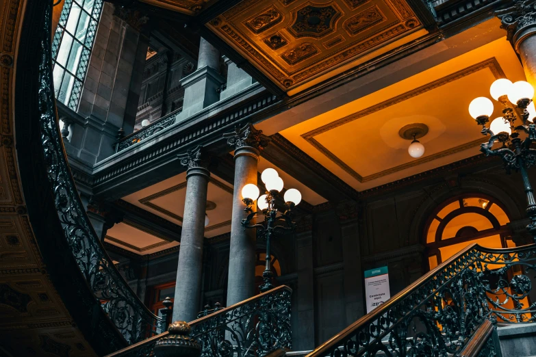 two staircases are lit up from underneath by streetlights