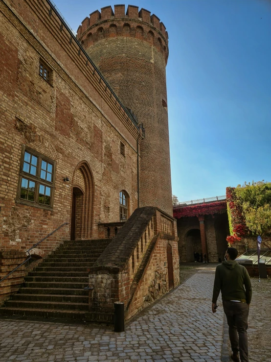 a tall brick building with lots of windows on top of it