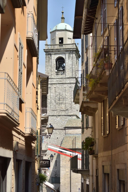 a clock tower between two buildings in the town