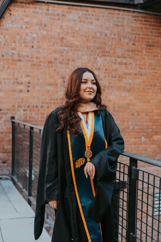 woman standing on stairs in front of brick building