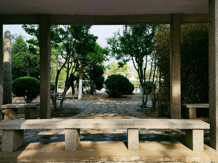 an outdoor bench at the end of a walkway