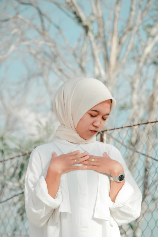 an image of a woman standing with her hands crossed