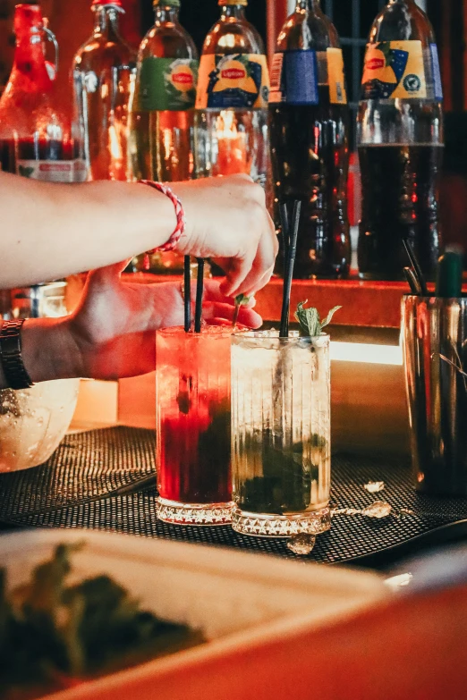 bartender making beverage in a bar, with colorful lights and liquor bottles behind