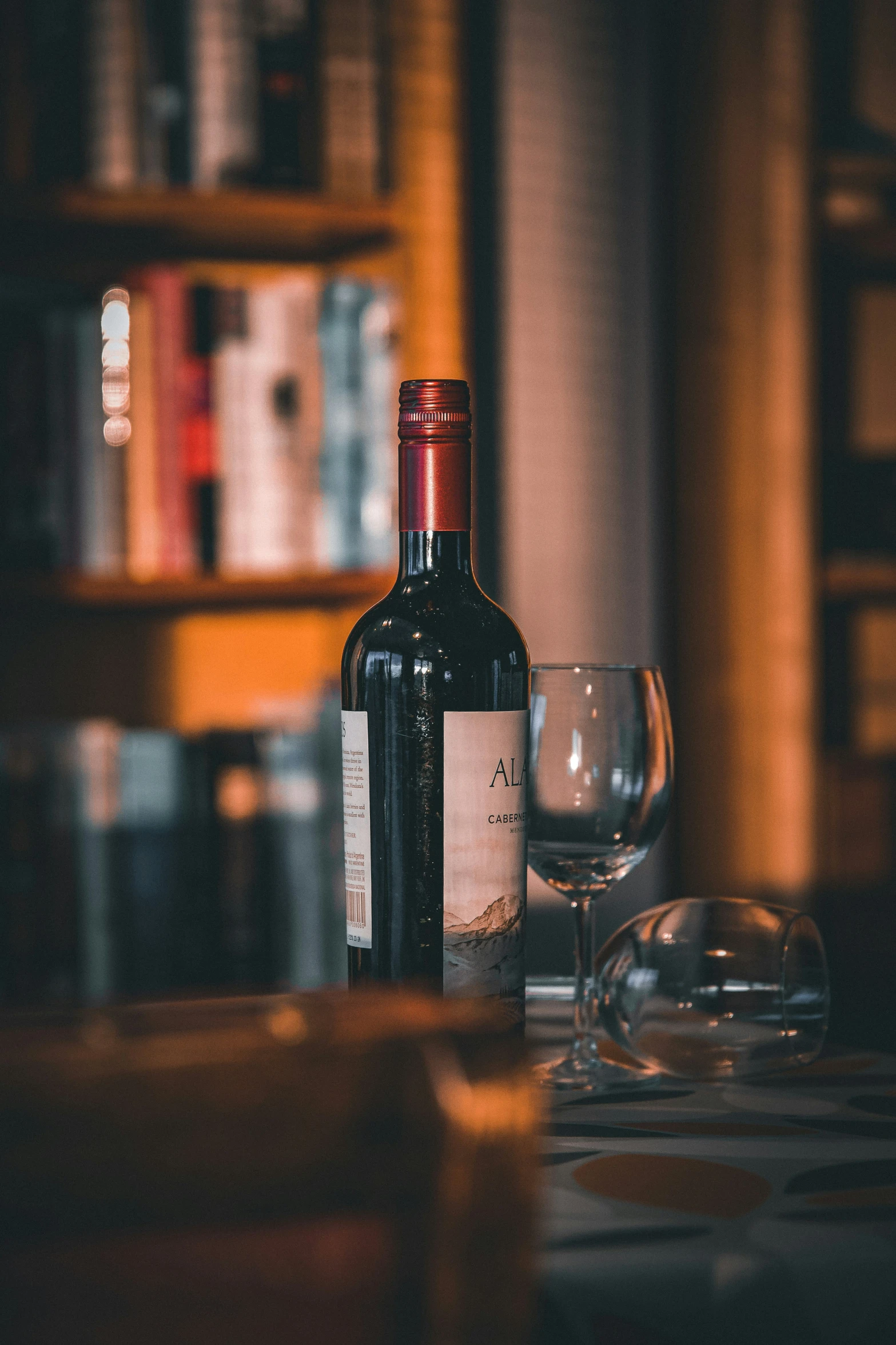 a bottle of wine and a glass on a table