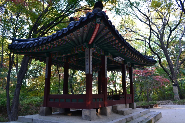 a small oriental gazebo surrounded by trees