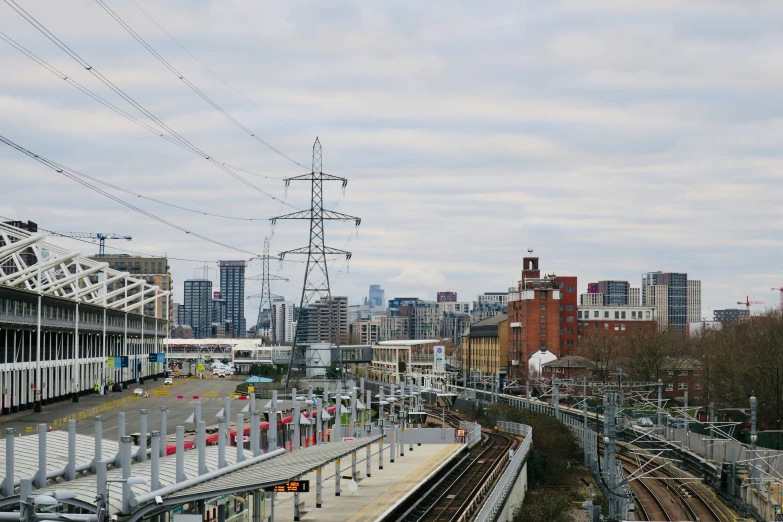 a train yard with multiple tracks and a bridge