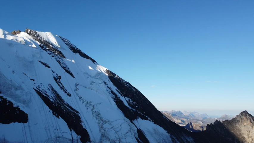 a skiier jumping in the air off of a mountain