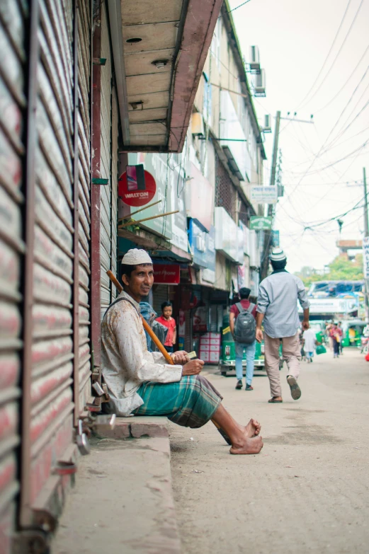 a man is sitting down in the middle of a city street