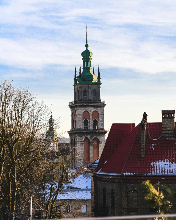 a clock tower in an old city with rooftops