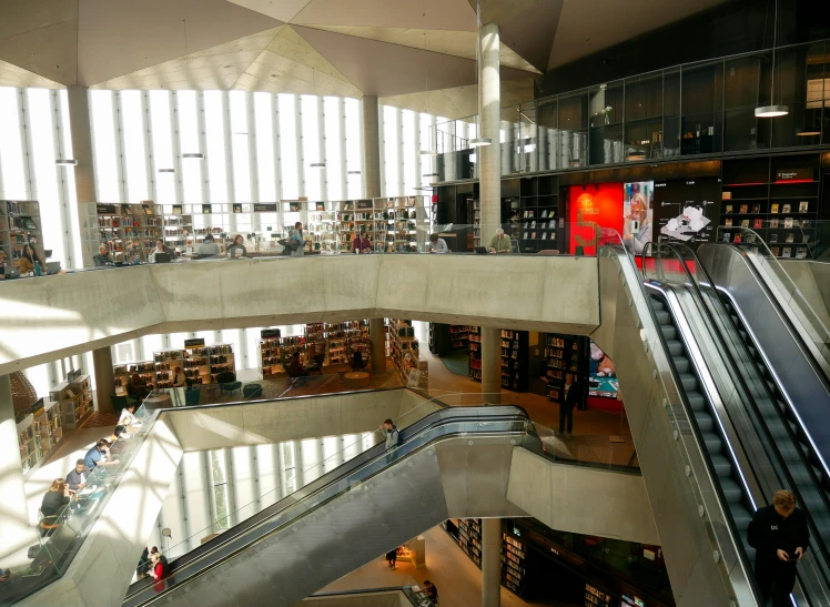 a large empty liry with an escalator going down it