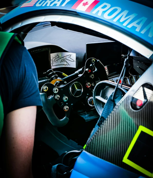 man sitting in an automobile looking in the cockpit