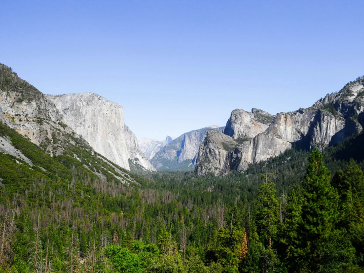 there are mountains and trees next to each other