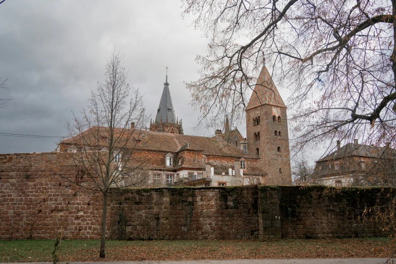 the building has several towers in it and is made from bricks