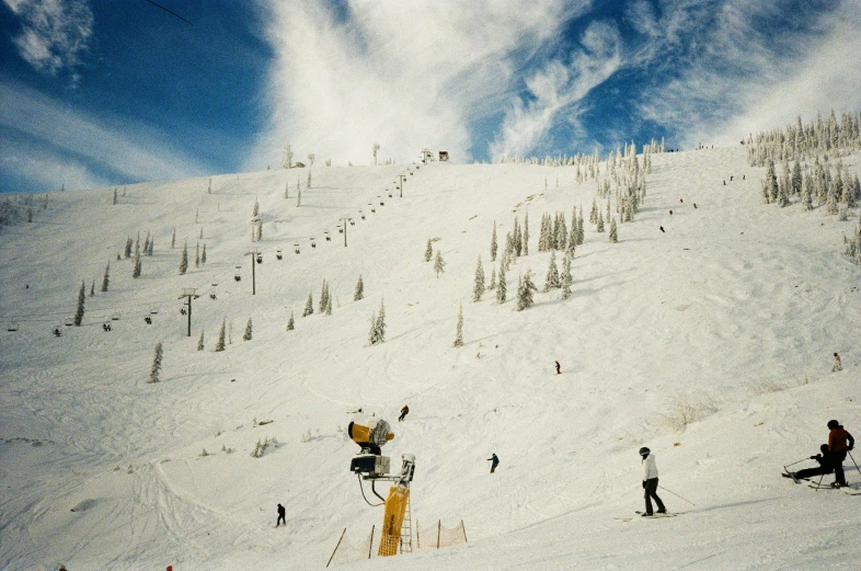 some people skiing on a very tall snowy hill