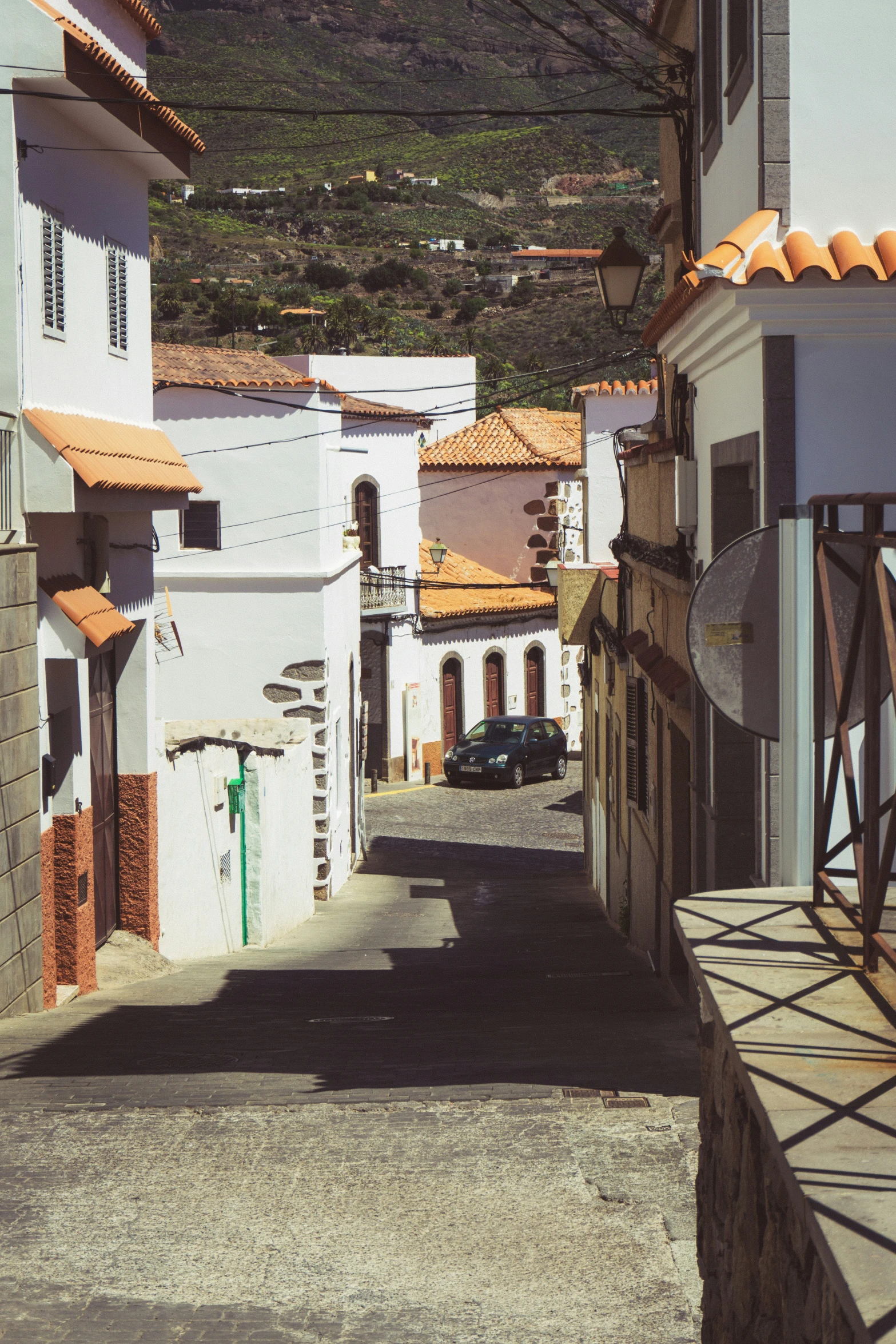 the narrow streets are empty with buildings on each side