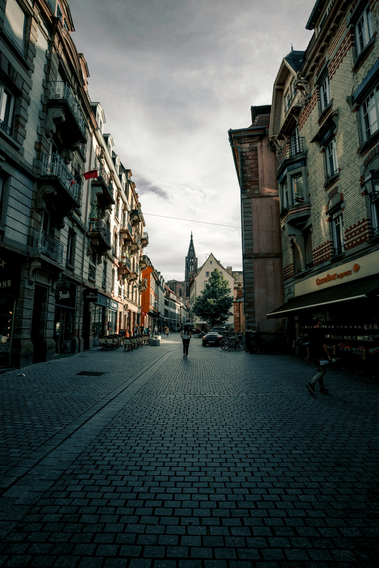 an image of people going down a cobblestone street