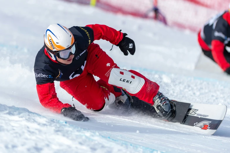 a person wearing red pants skis down a snow covered slope