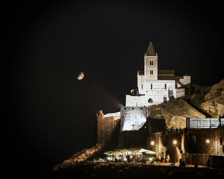 a castle sitting on top of a hill at night