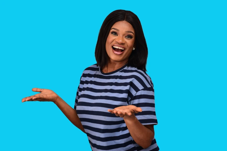 an african american woman with her arms out and wearing striped shirt