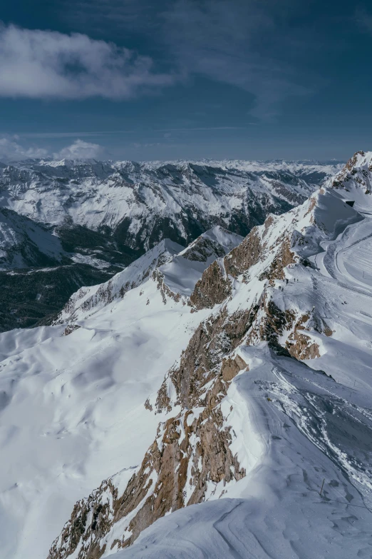 an expansive view of mountains with snow covering the ground