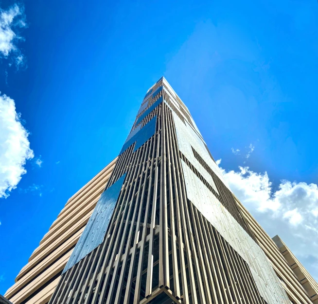 an upward view of a skyscr and some clouds