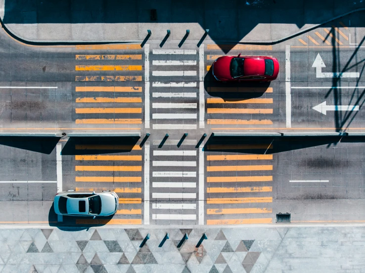 an overhead view of a city street with traffic lights and vehicles