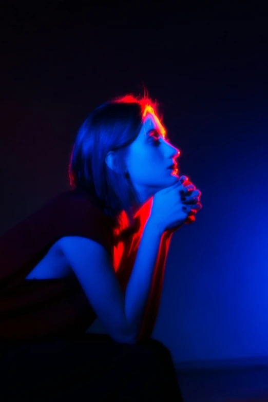 the woman's body is illuminated by blue and red lights