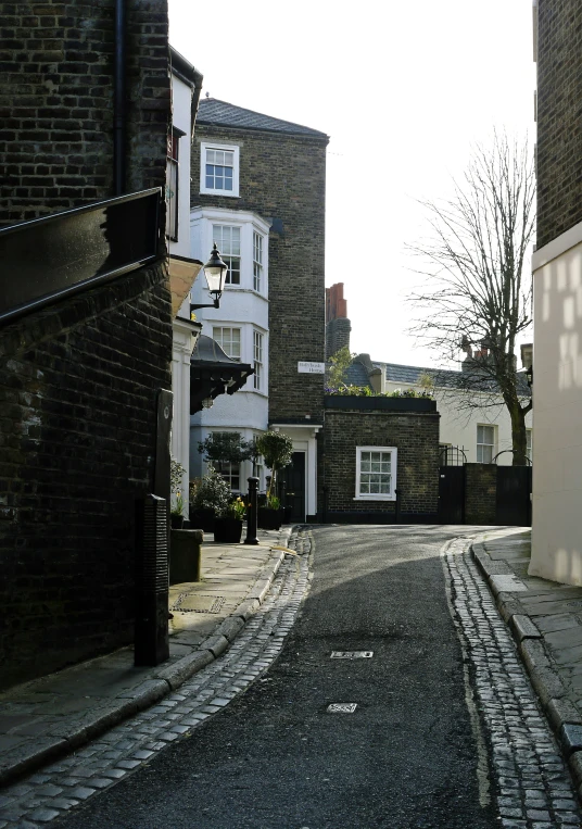 an empty street between two buildings near one another