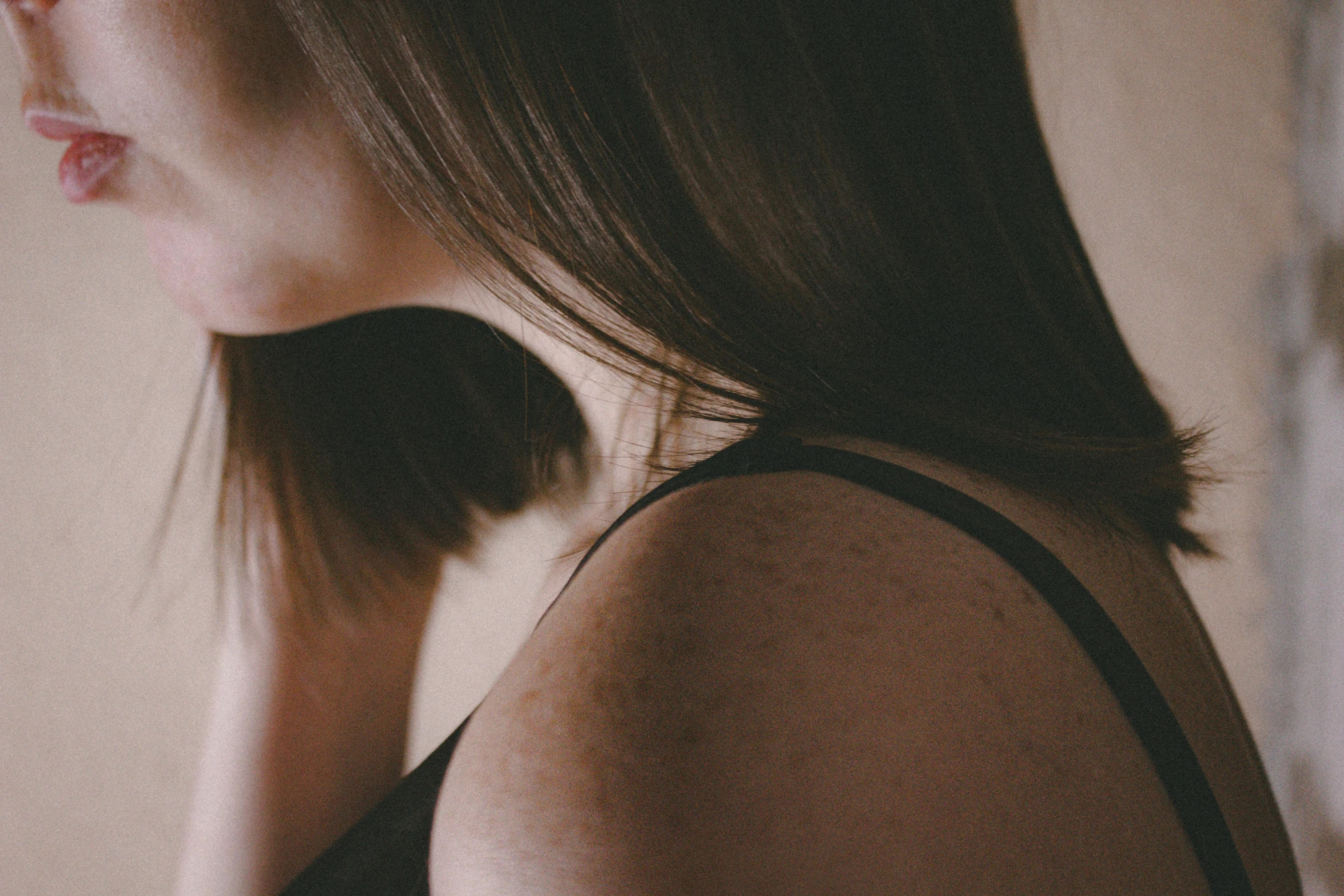 the woman's top has very long hair and is wearing a tank top