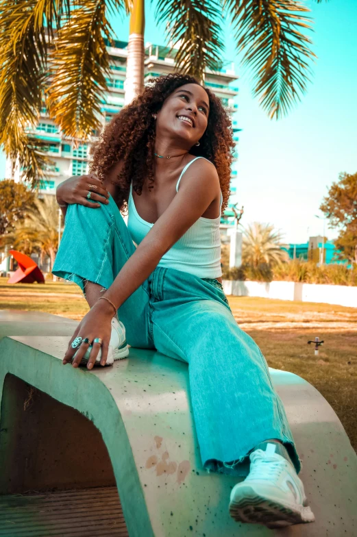 a young woman is sitting on a concrete bench