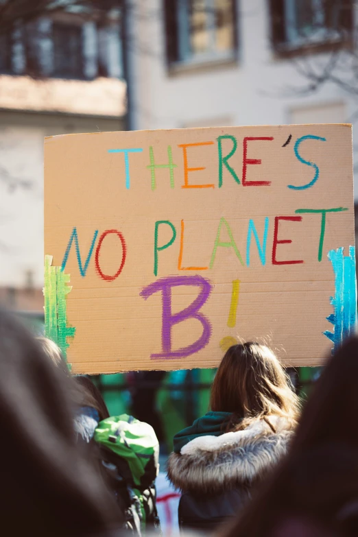 a sign with some writing on it in front of people