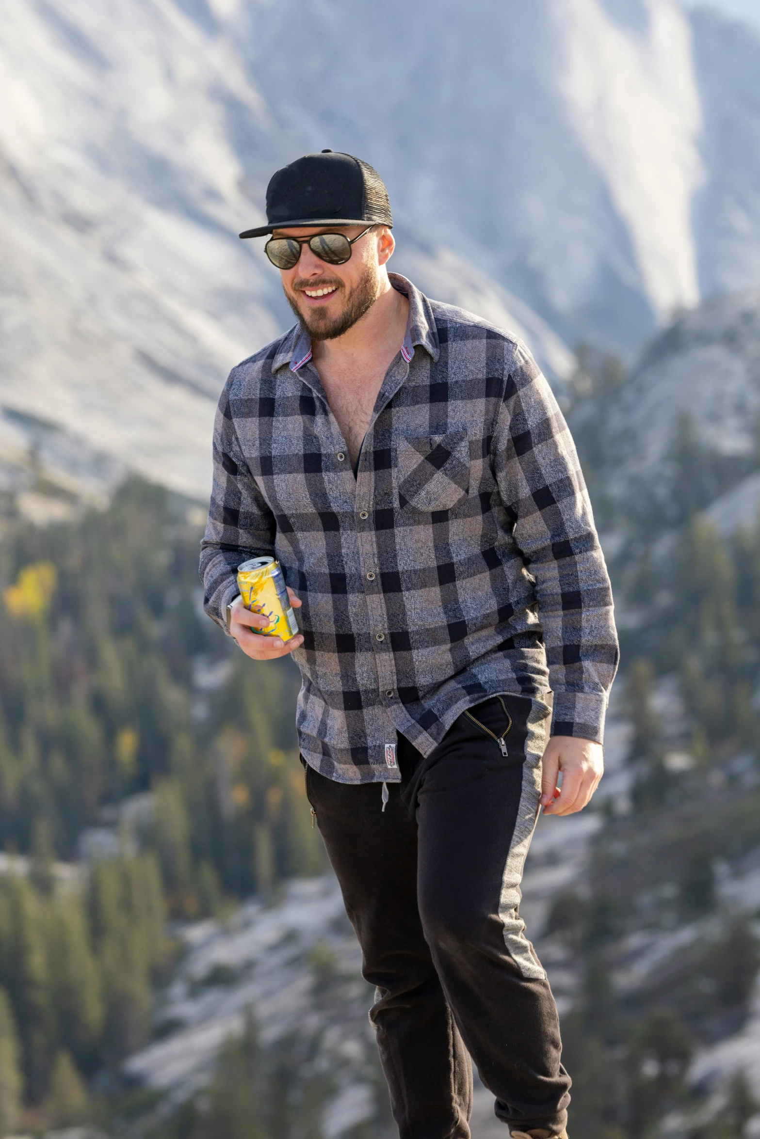 a man is wearing sunglasses while standing on a ledge