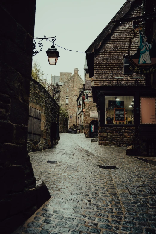 an old cobble stone street with a lamp post