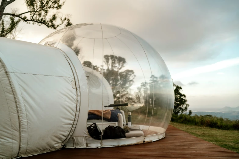 two bubble houses on a deck in the woods