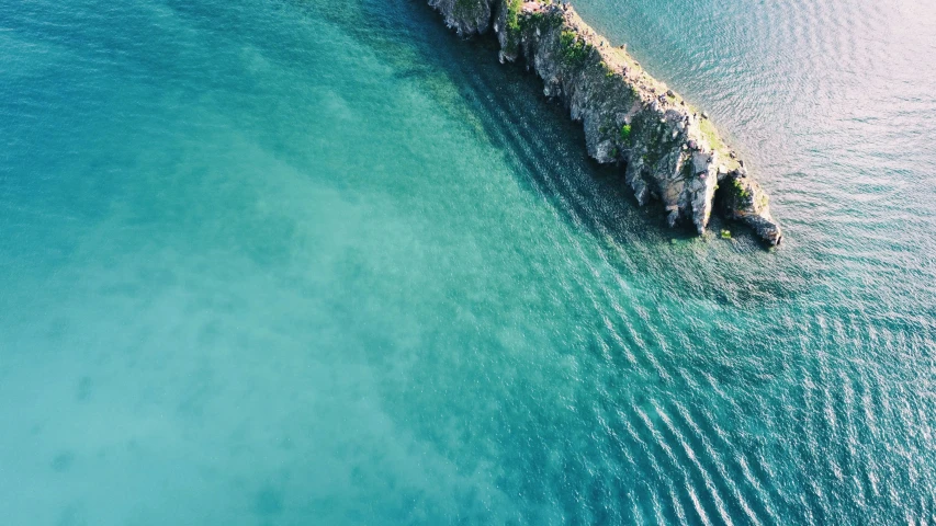 an aerial po of a concrete dock in blue water