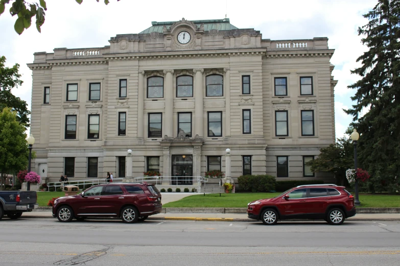 the cars are parked in front of the large stone building