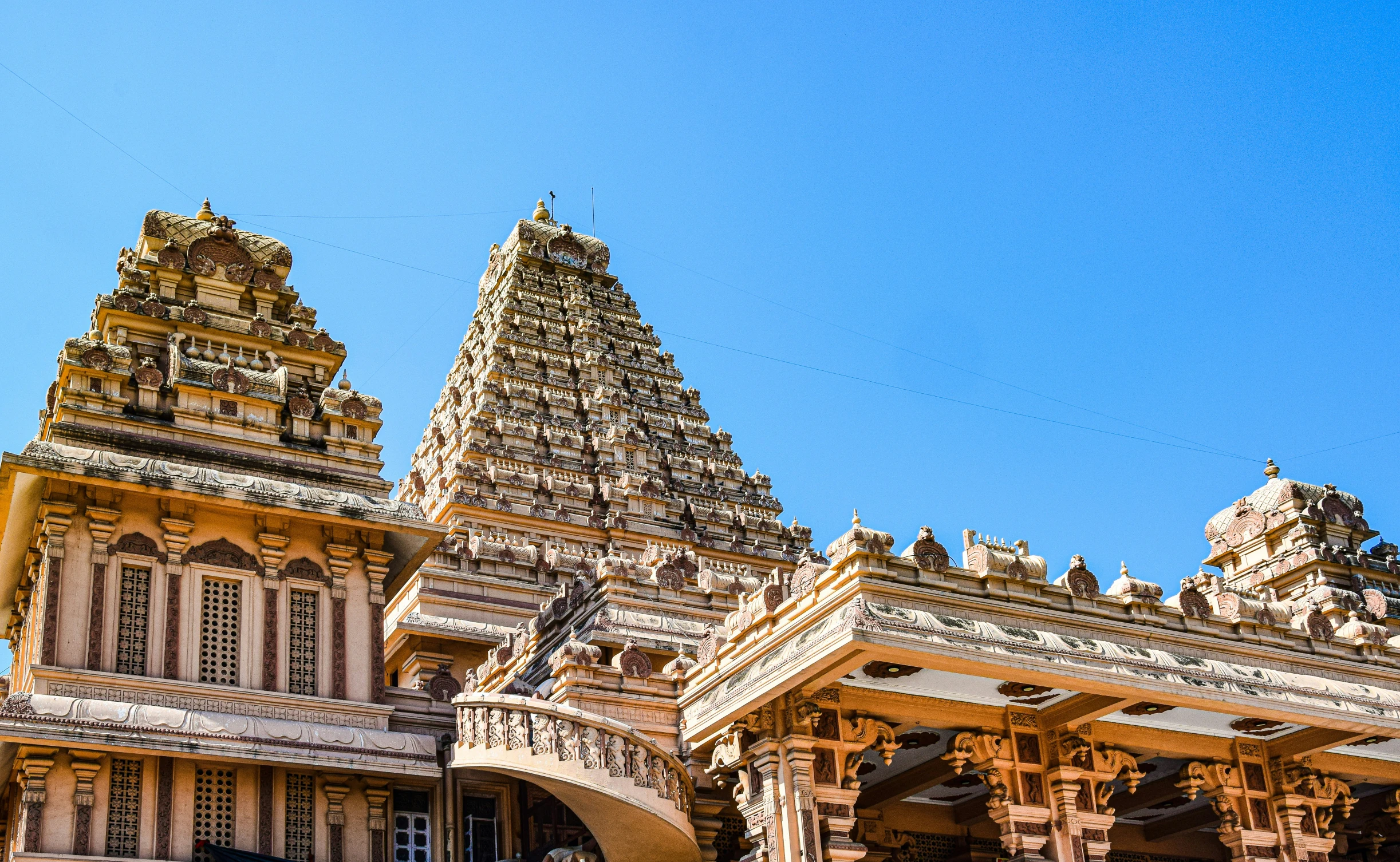 an elaborate structure with multiple spires sits against a blue sky