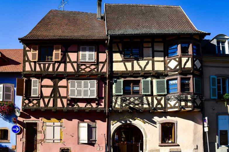 a two story house with two balconies and an awning