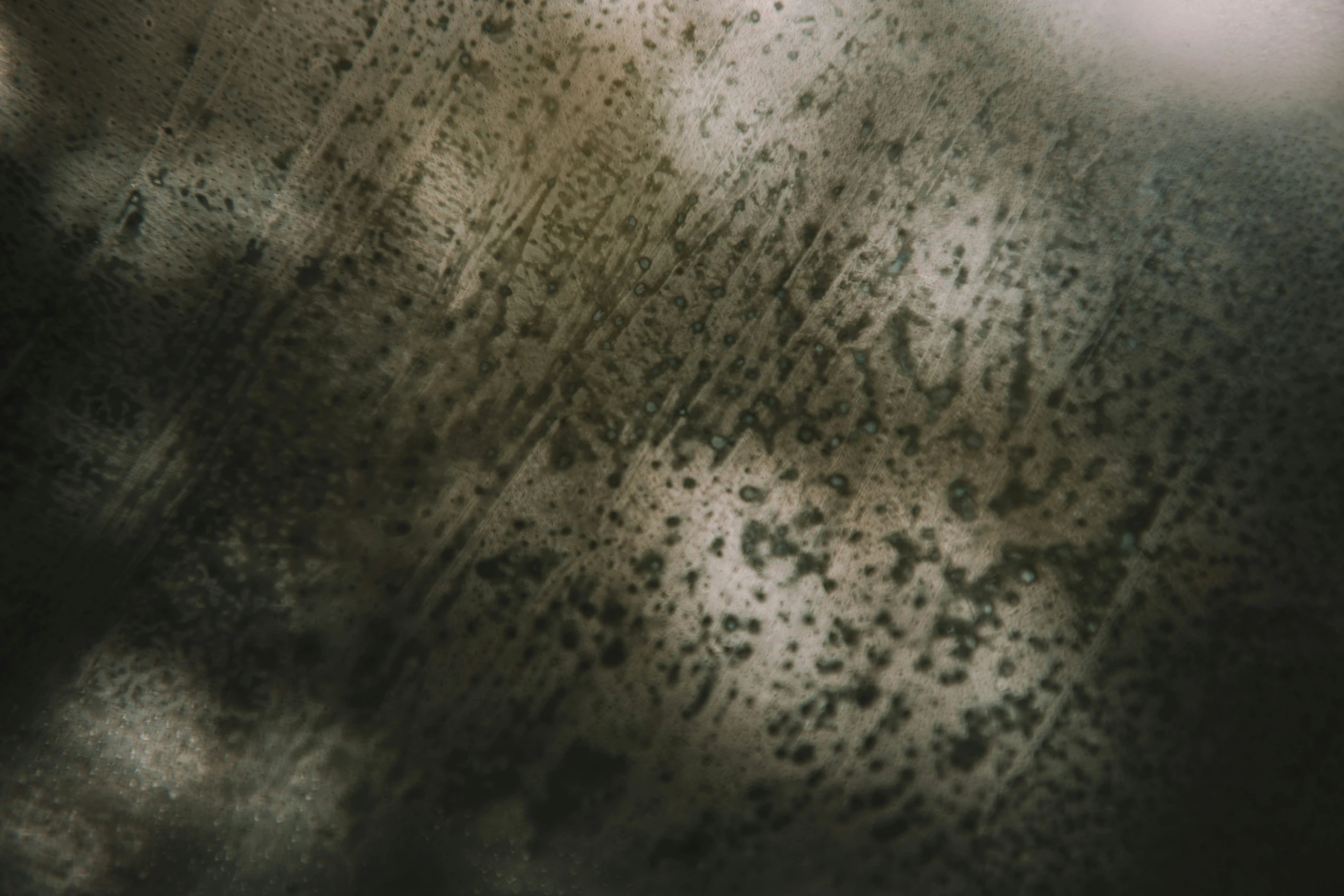 a rain covered window that has a brown background