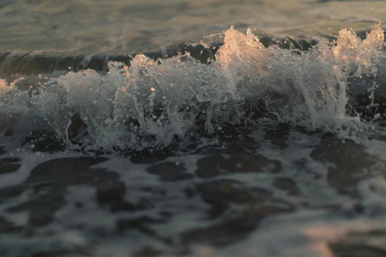 closeup s of waves breaking over the rock